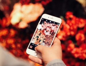 person holding gold iPhone 6 taking photo